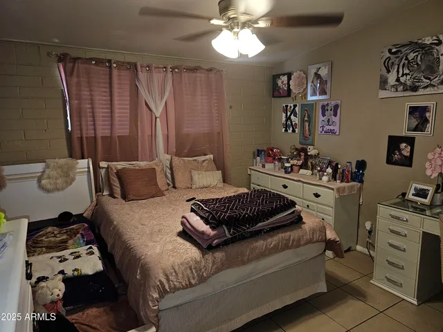 a bedroom with bed and a chandelier