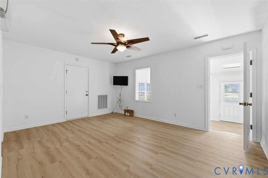 18501 Branders Bridge Road Colonial Heights, VA 23834 - Photo 9 of 43 a view of empty room with wooden floor and ceiling fan