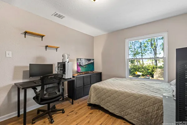 a view of a workspace with furniture and a window