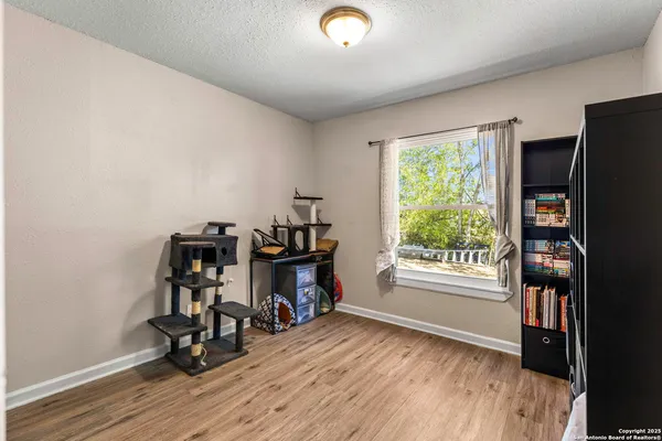 a view of wooden floor and windows in a room