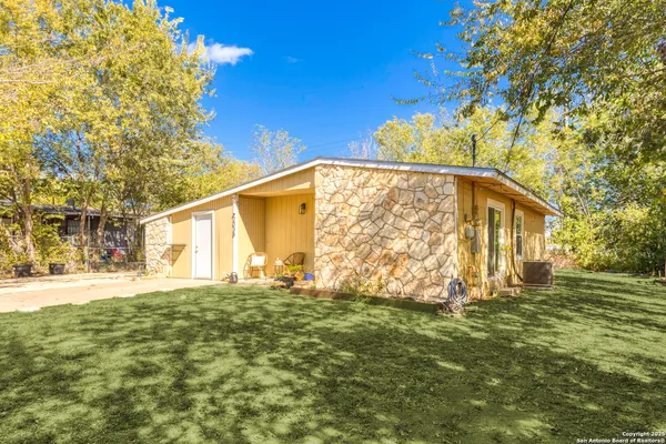 a view of an house with backyard space and garden