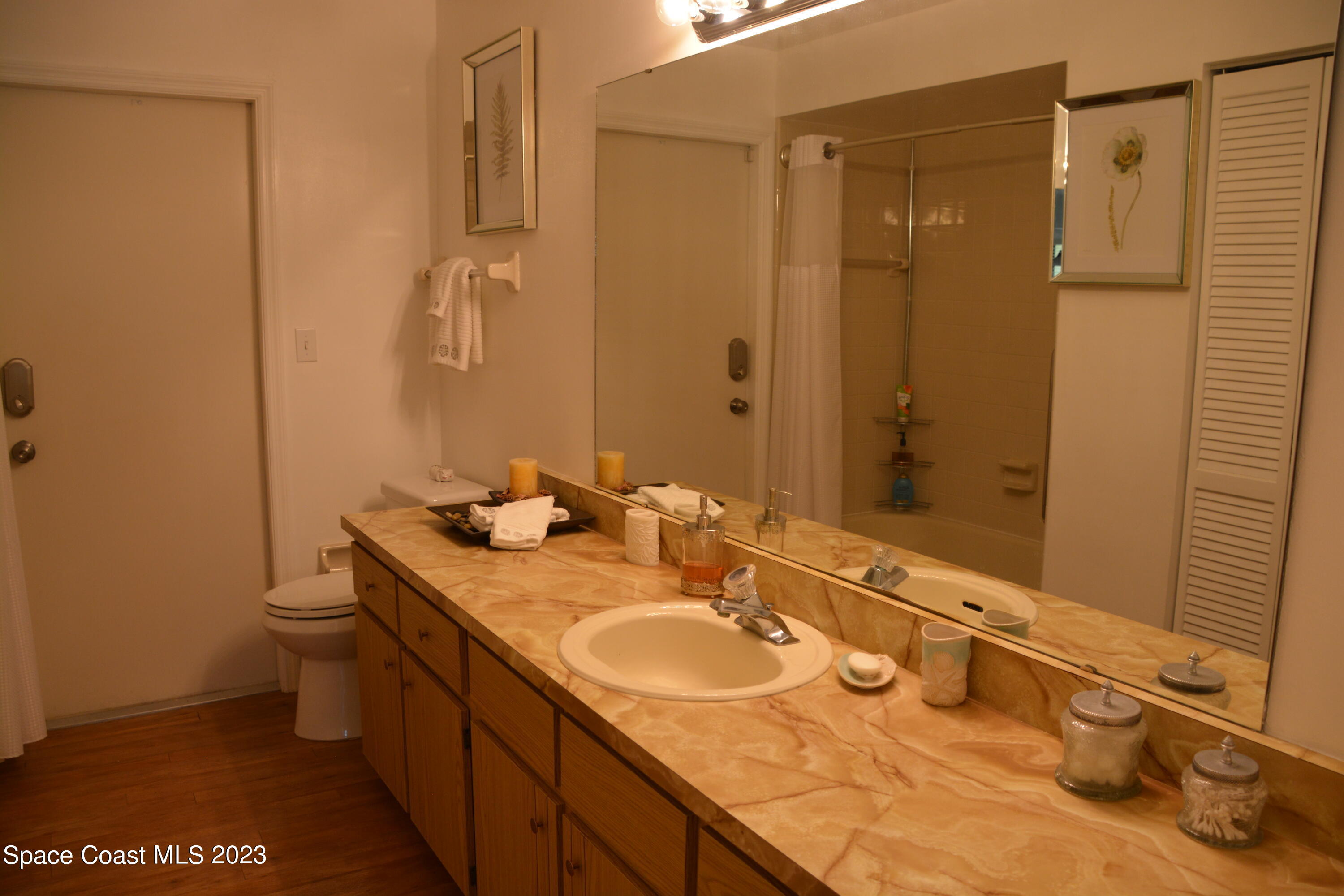 1045 Pine Island Road Merritt Island, FL 32953 - Photo 19 of 42 a bathroom with a granite countertop sink toilet and shower