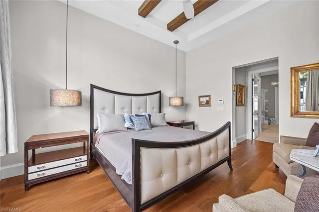 a bedroom with a bed a mirror and desk