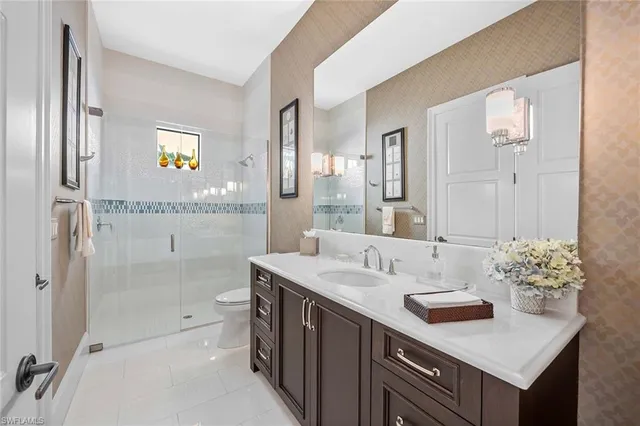 a bathroom with a sink double vanity granite tub and shower