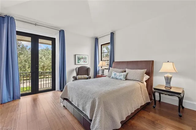 a bedroom with a large bed and a lamp on table