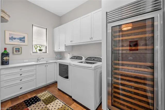 a utility room with cabinets washer and dryer