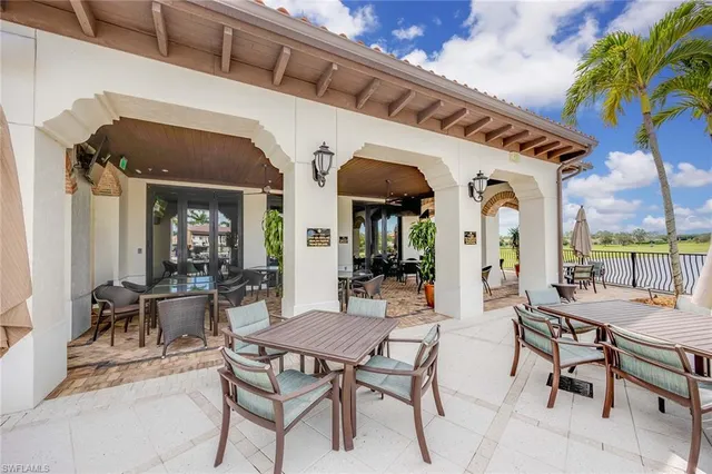 a view of a dining area with furniture and a potted plant