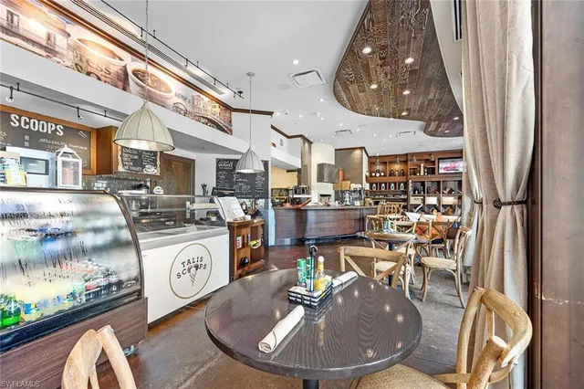 a view of a livingroom with furniture and kitchen view