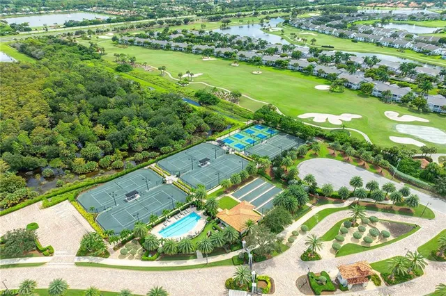 an aerial view of a residential houses with outdoor space and street view