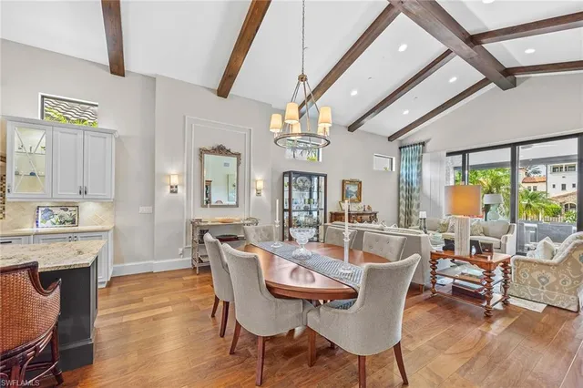 a dining room with furniture a rug and wooden floor