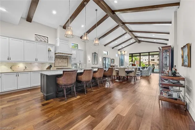 a open kitchen with white cabinets and stainless steel appliances