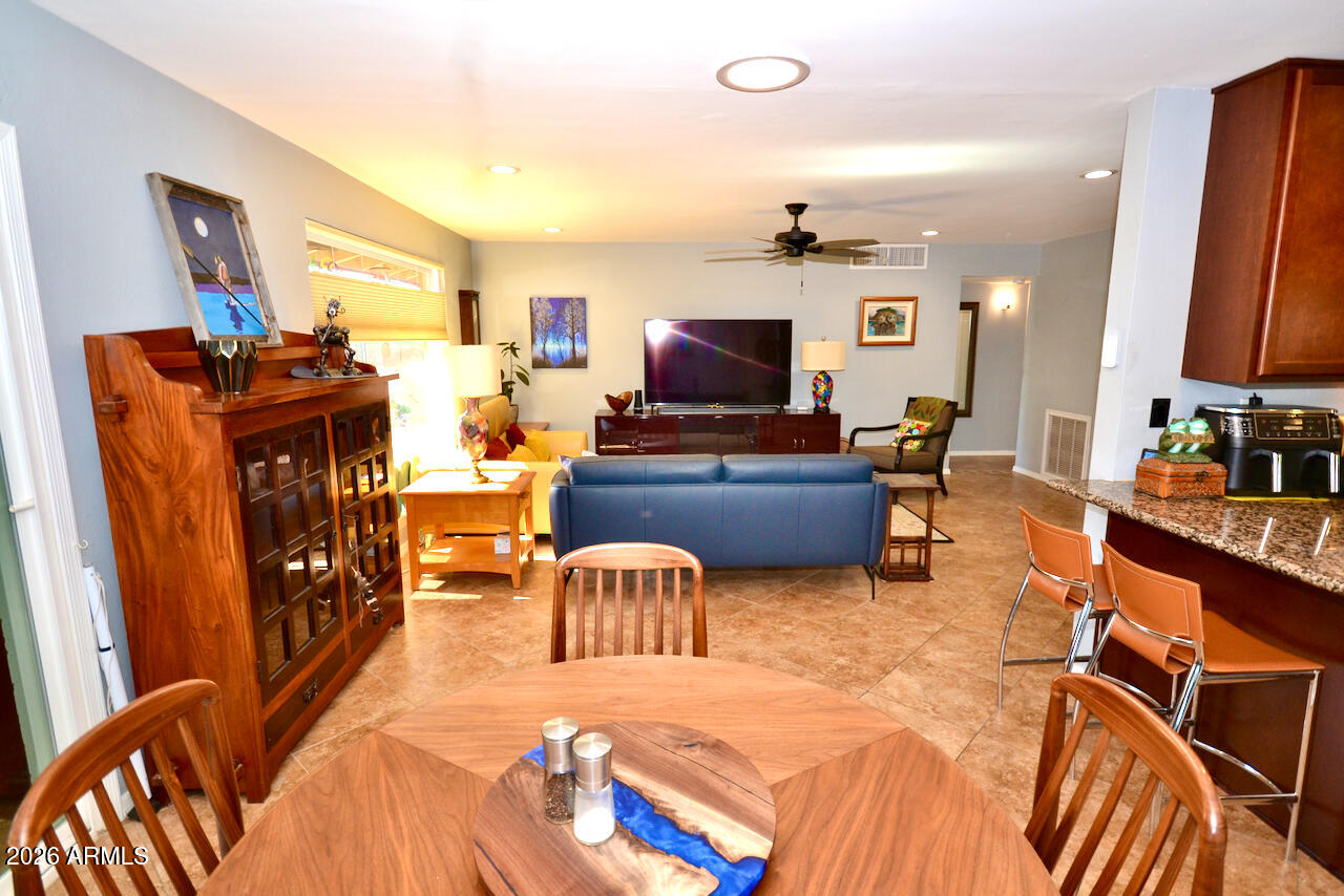 1215 West Colter Street Phoenix, AZ 85013 - Photo 17 of 41 a living room with furniture and a flat screen tv