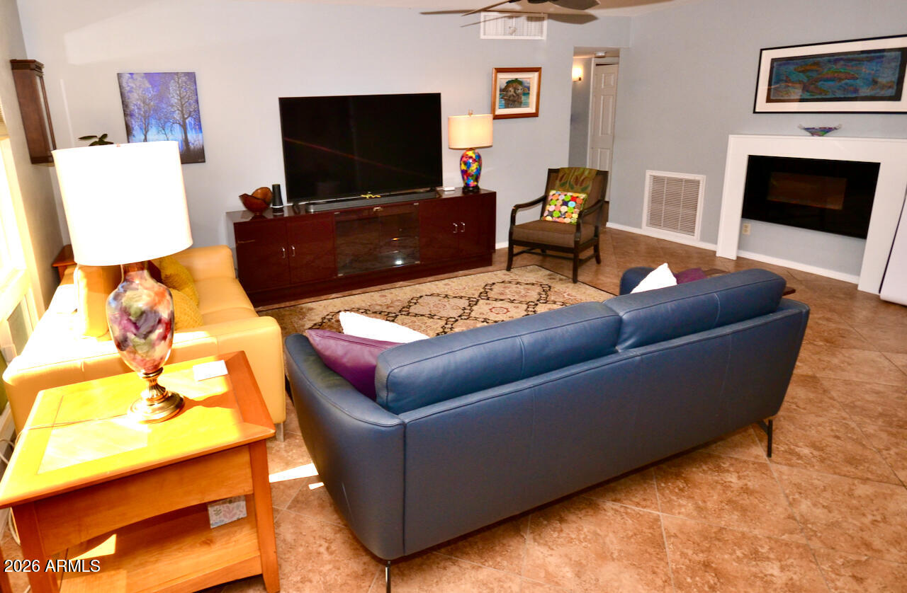 1215 West Colter Street Phoenix, AZ 85013 - Photo 22 of 41 a living room with furniture and a flat screen tv