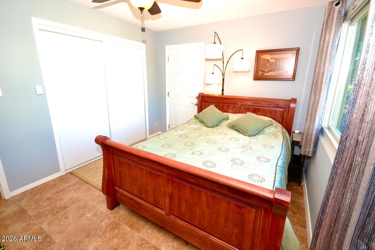 1215 West Colter Street Phoenix, AZ 85013 - Photo 29 of 41 a bed sitting in a bedroom next to a window