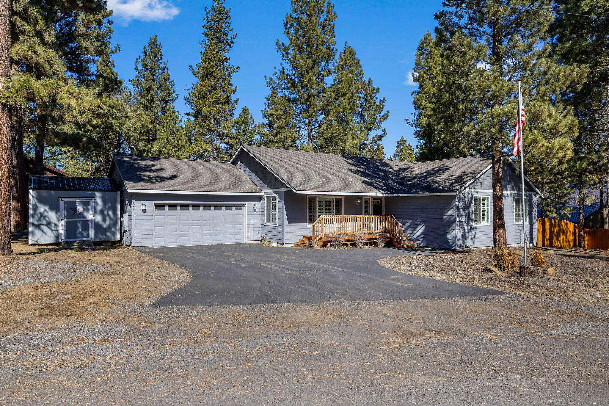 17064 Sacramento Road Bend, OR 97707 - Photo 3 of 50 a front view of a house with a garden and tree