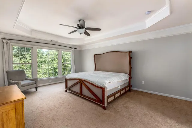 a room with a bed and large window