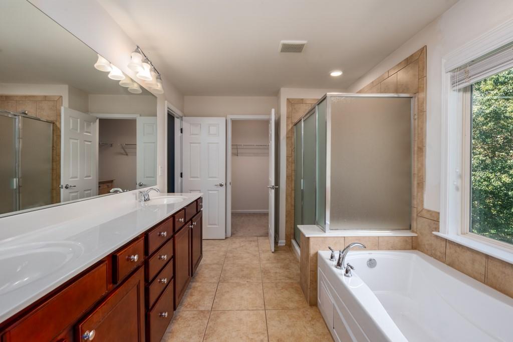 146 Edgewater Trail Canton, GA 30115 - Photo 13 of 25 a spacious bathroom with a large tub shower and sink