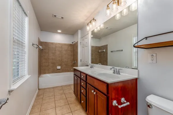 a bathroom with a sink mirror vanity and toilet