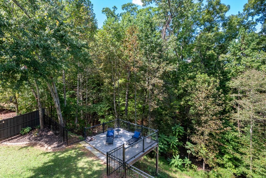 146 Edgewater Trail Canton, GA 30115 - Photo 24 of 25 a backyard of a house with table and chairs in a forest