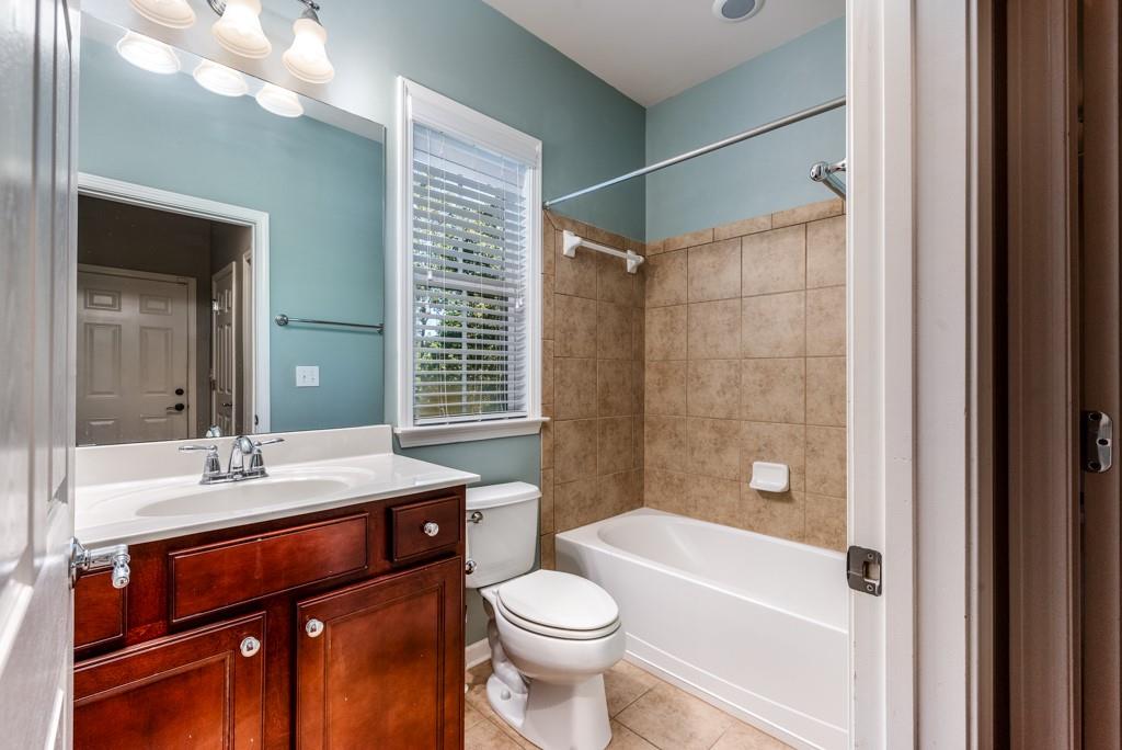 146 Edgewater Trail Canton, GA 30115 - Photo 10 of 25 a bathroom with a sink a toilet and shower