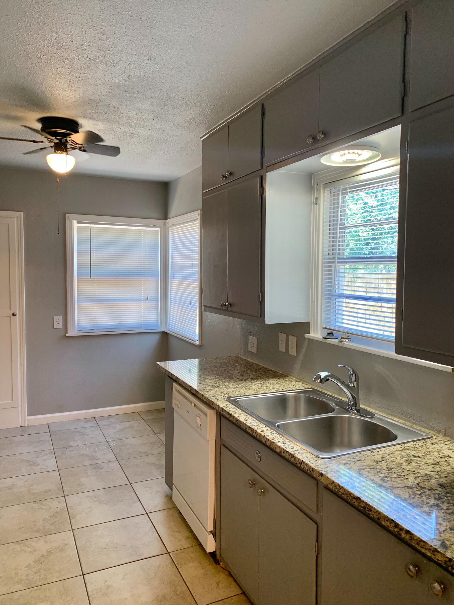 2510 39th Street Lubbock, TX 79413 - Photo 5 of 12 a kitchen with a sink a counter top space and cabinets