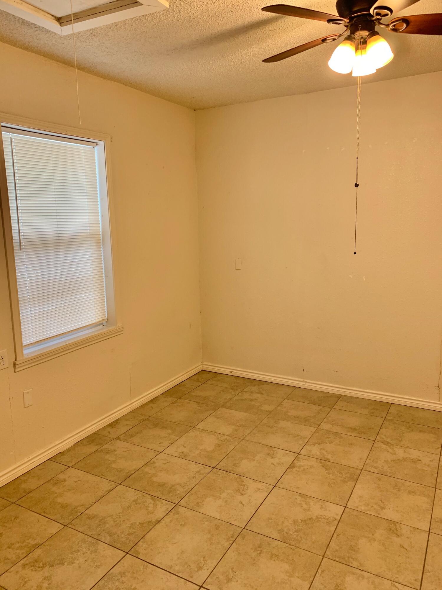 2510 39th Street Lubbock, TX 79413 - Photo 6 of 12 a view of an empty room with a window