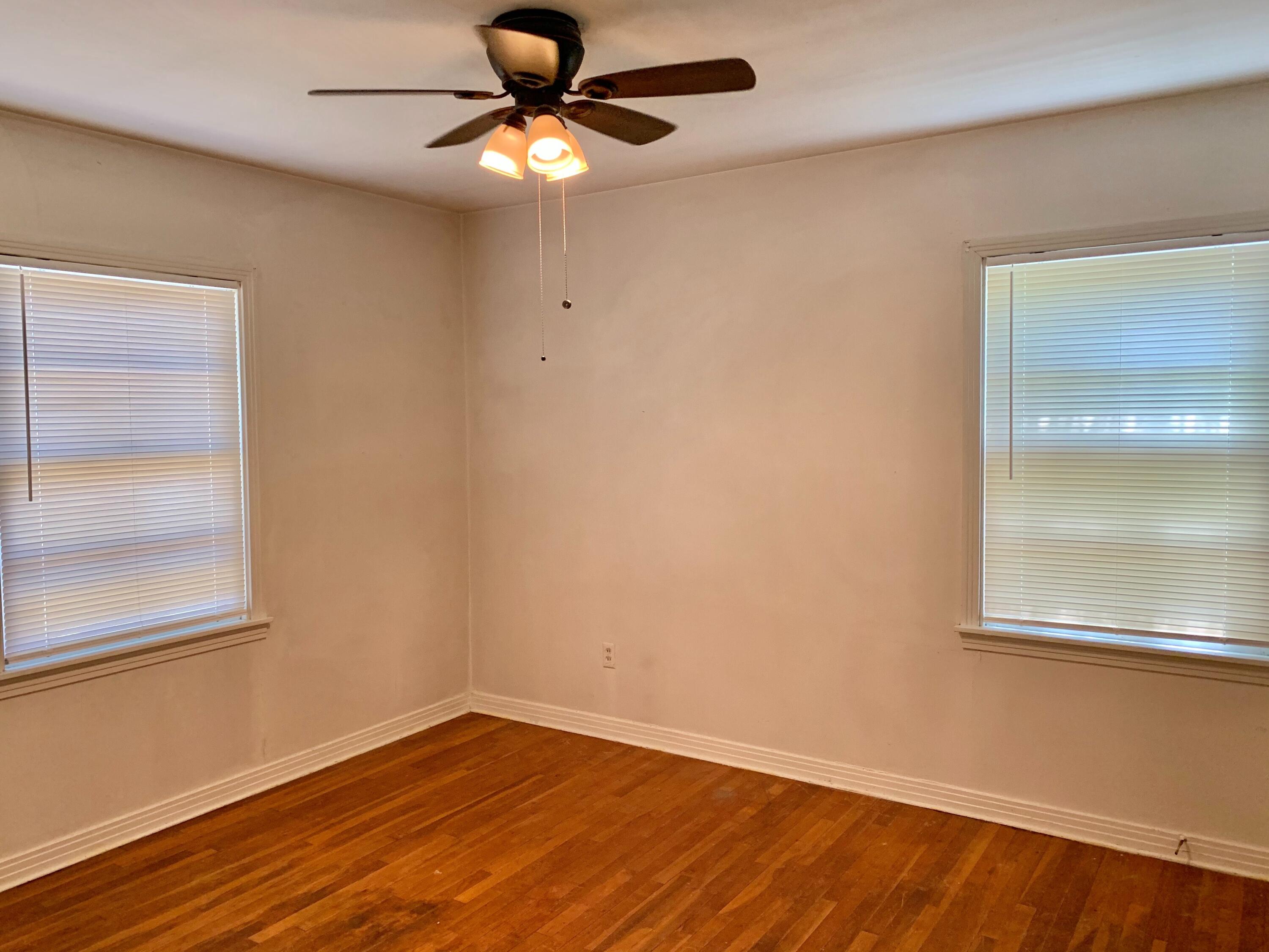2510 39th Street Lubbock, TX 79413 - Photo 10 of 12 an empty room with a window and wooden floor