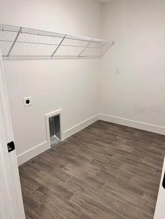 a view of a room with wooden floor and cabinet