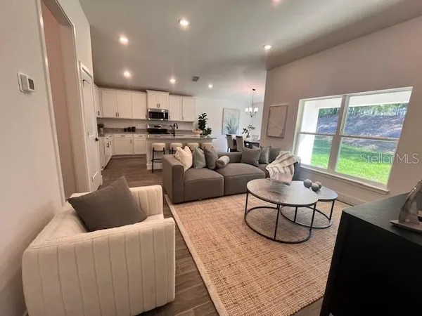 a living room with furniture and a large window