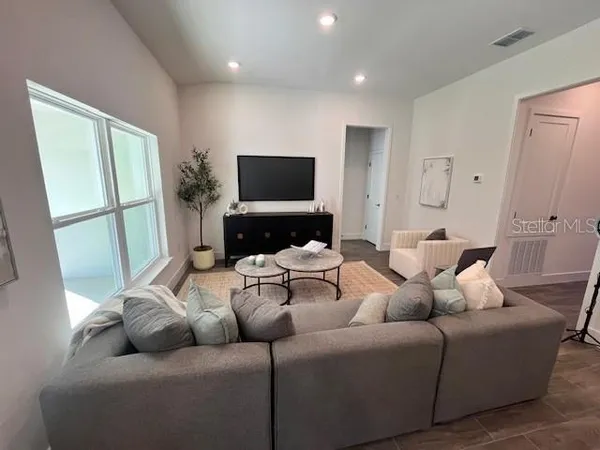 a living room with furniture and a flat screen tv