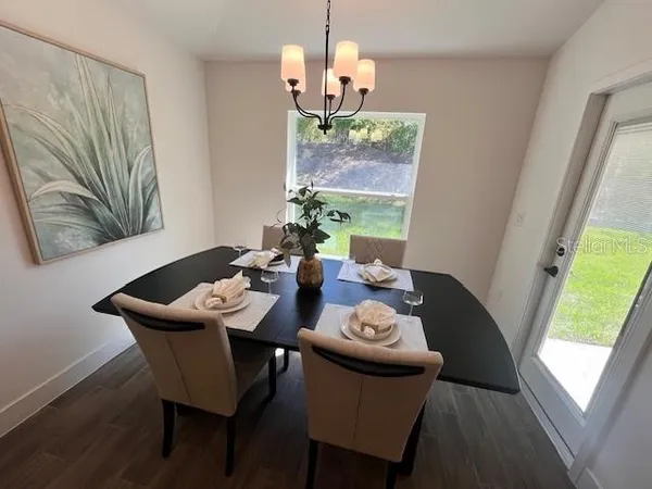 a dining room with furniture and wooden floor