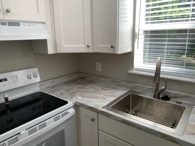 a view kitchen with a sink and cabinets