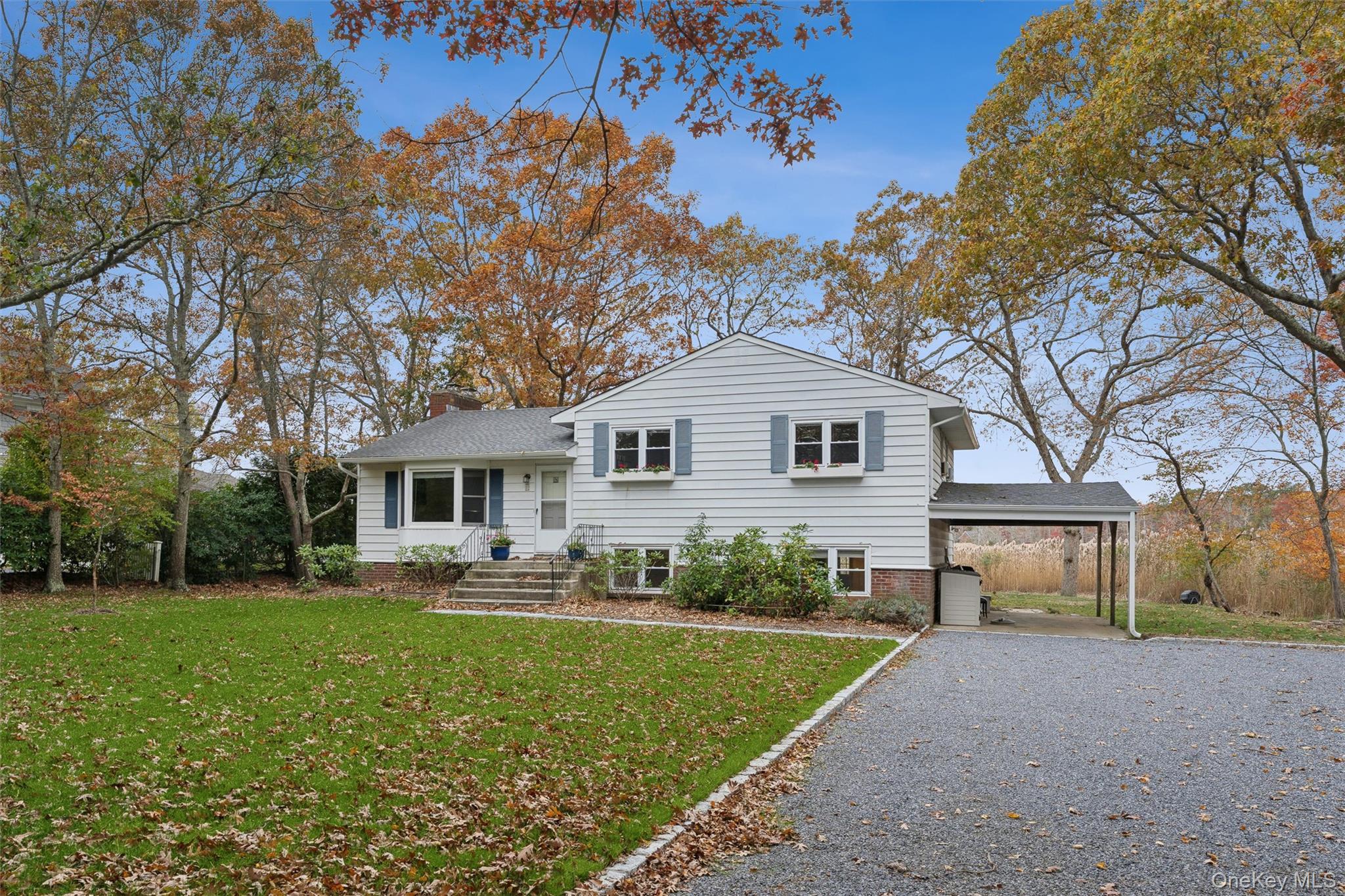23 Old Main Road Quogue, NY 11959 - Photo 1 of 19 a front view of house with yard and green space