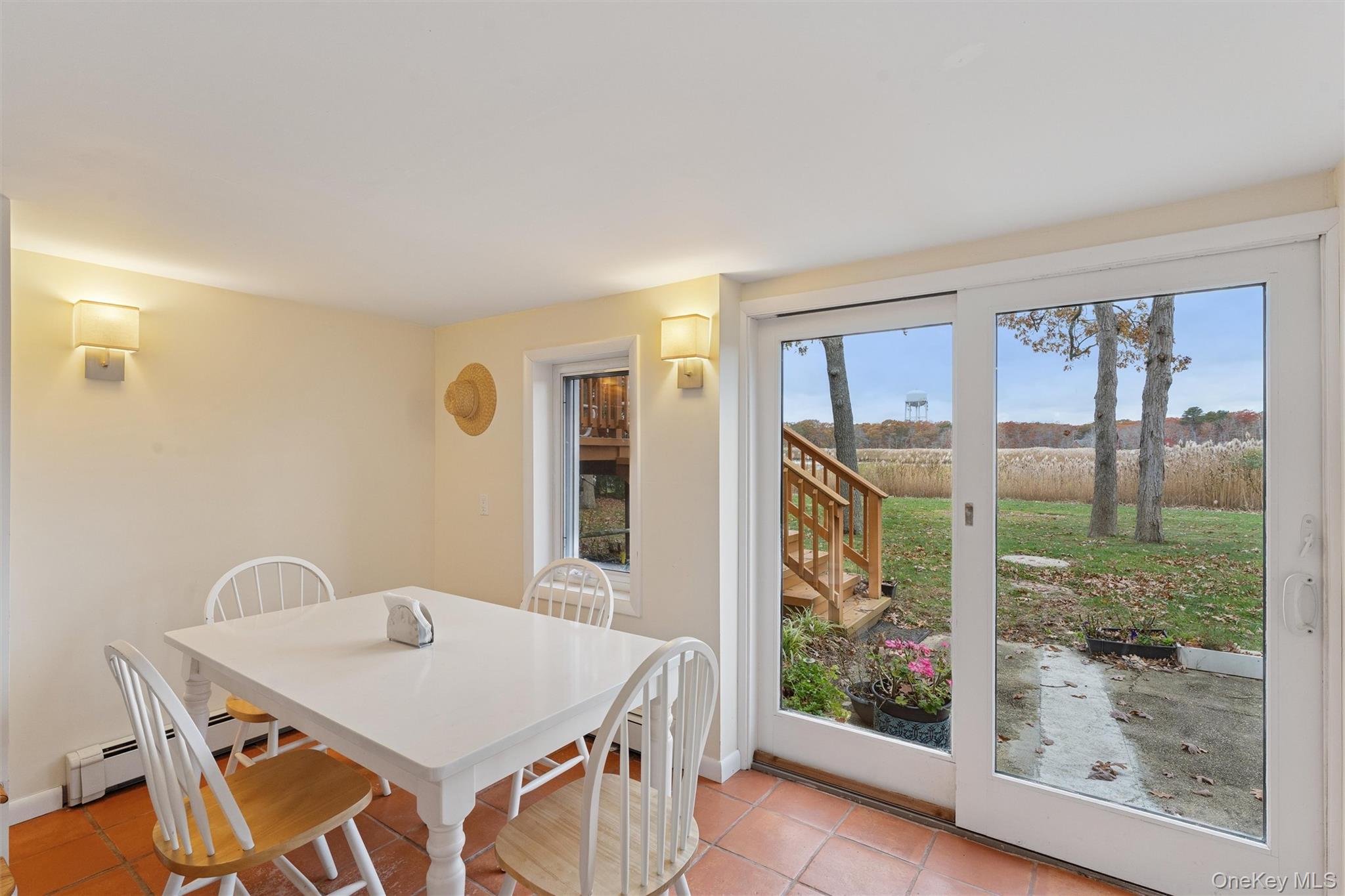 23 Old Main Road Quogue, NY 11959 - Photo 11 of 19 a view of a dining room with furniture window and wooden floor