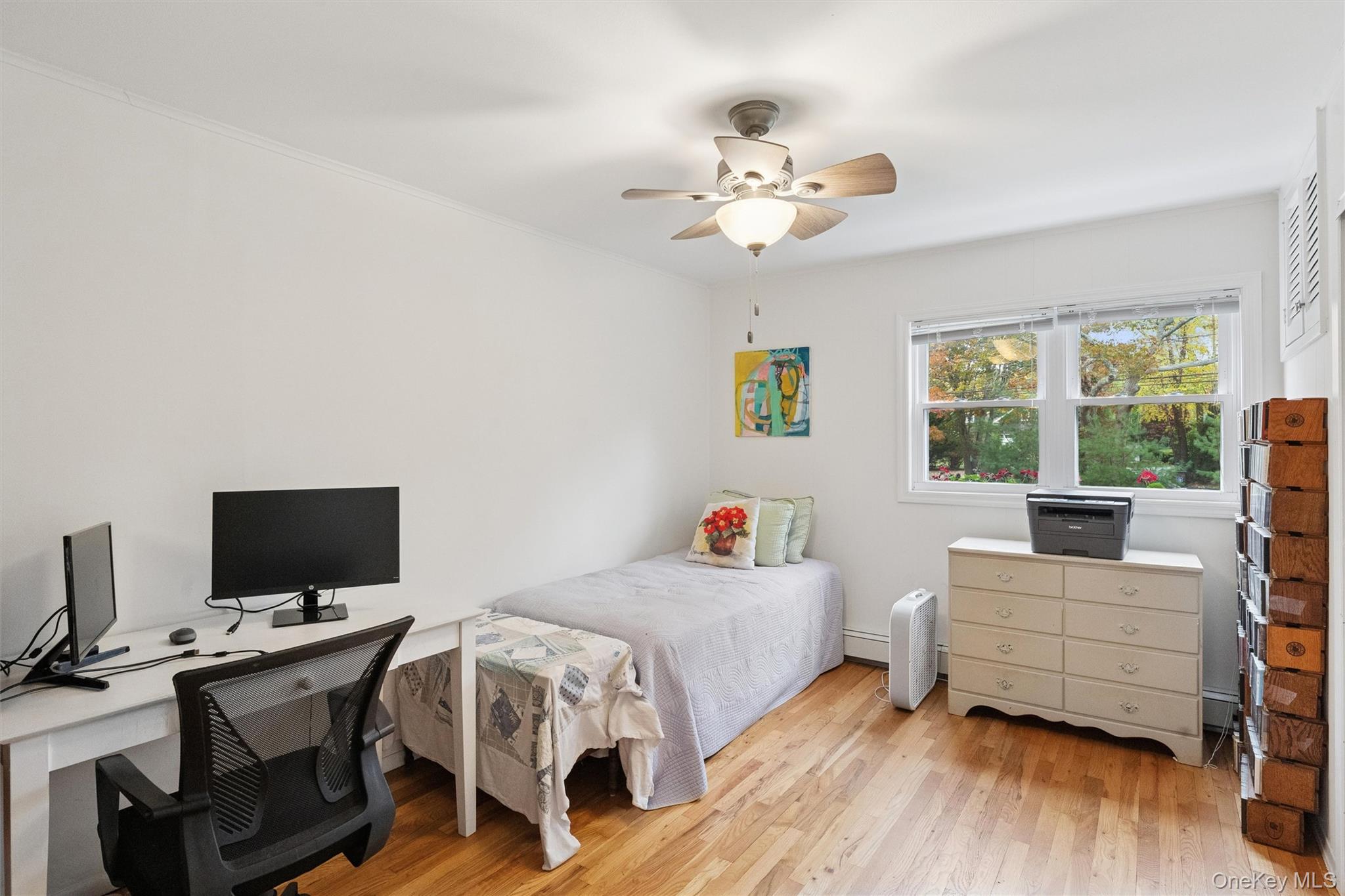 23 Old Main Road Quogue, NY 11959 - Photo 12 of 19 a bedroom with a bed and large windows