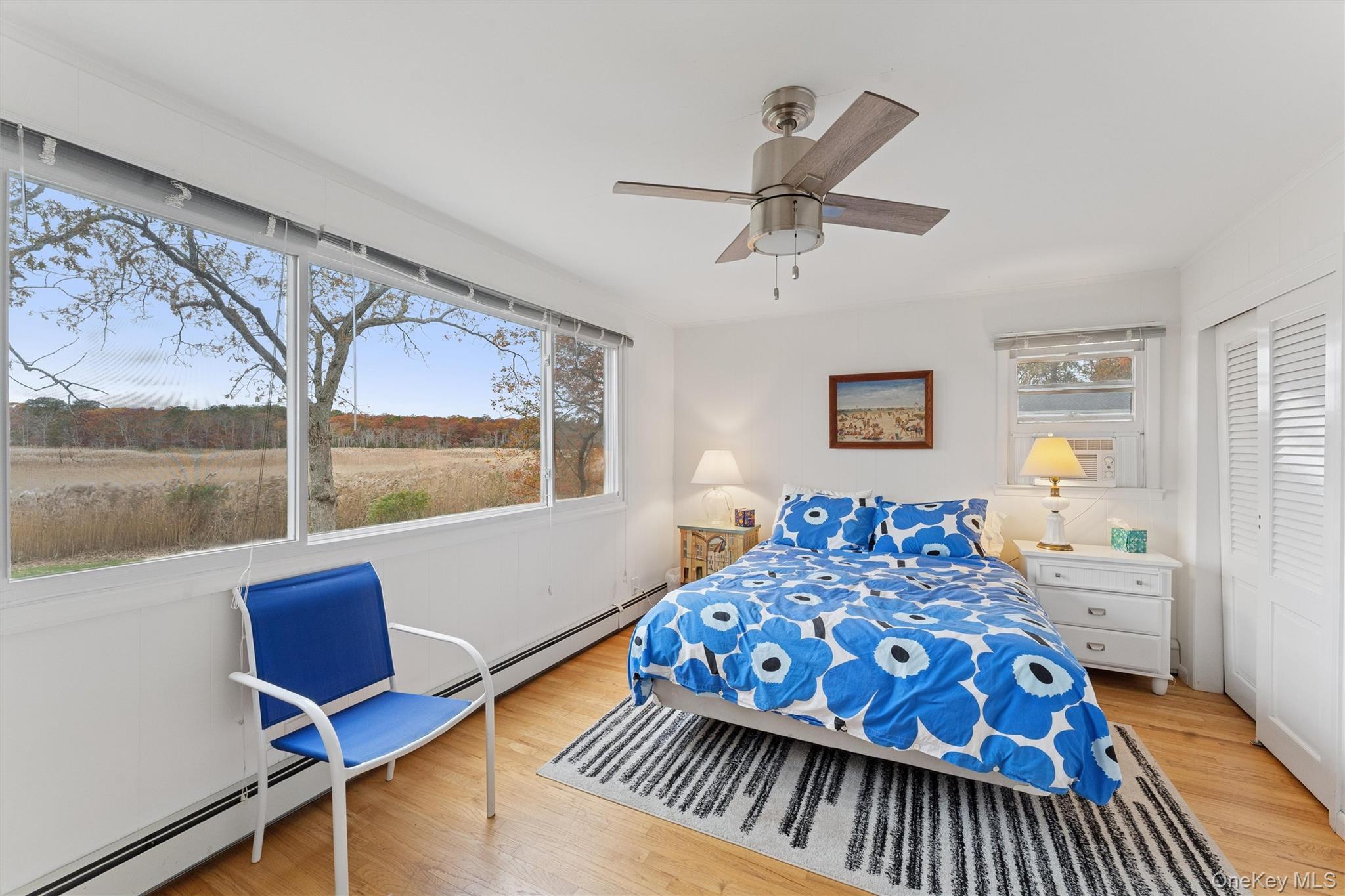23 Old Main Road Quogue, NY 11959 - Photo 14 of 19 a bedroom with a bed and wooden floor
