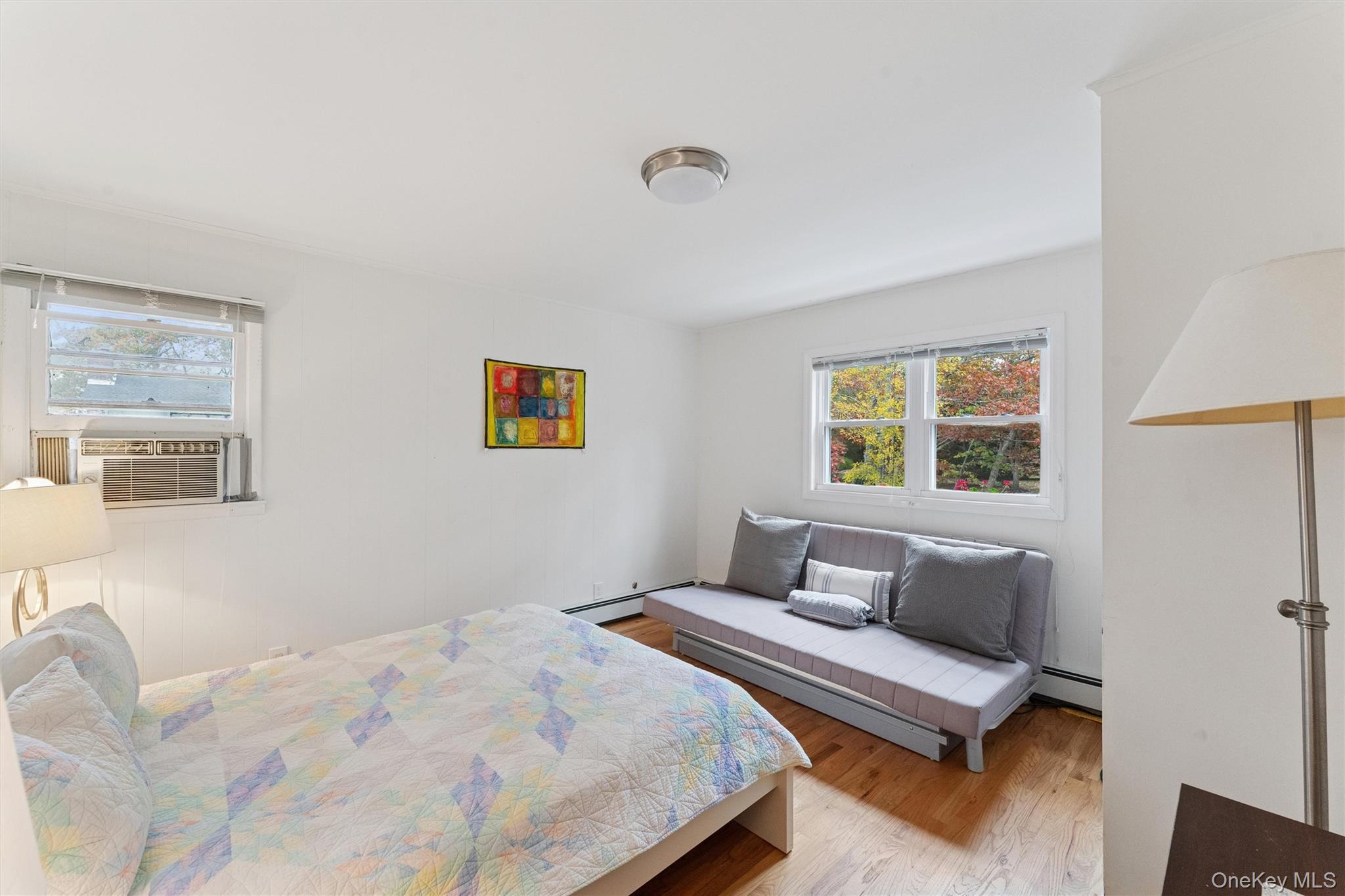 23 Old Main Road Quogue, NY 11959 - Photo 17 of 19 a bedroom with a bed and a window