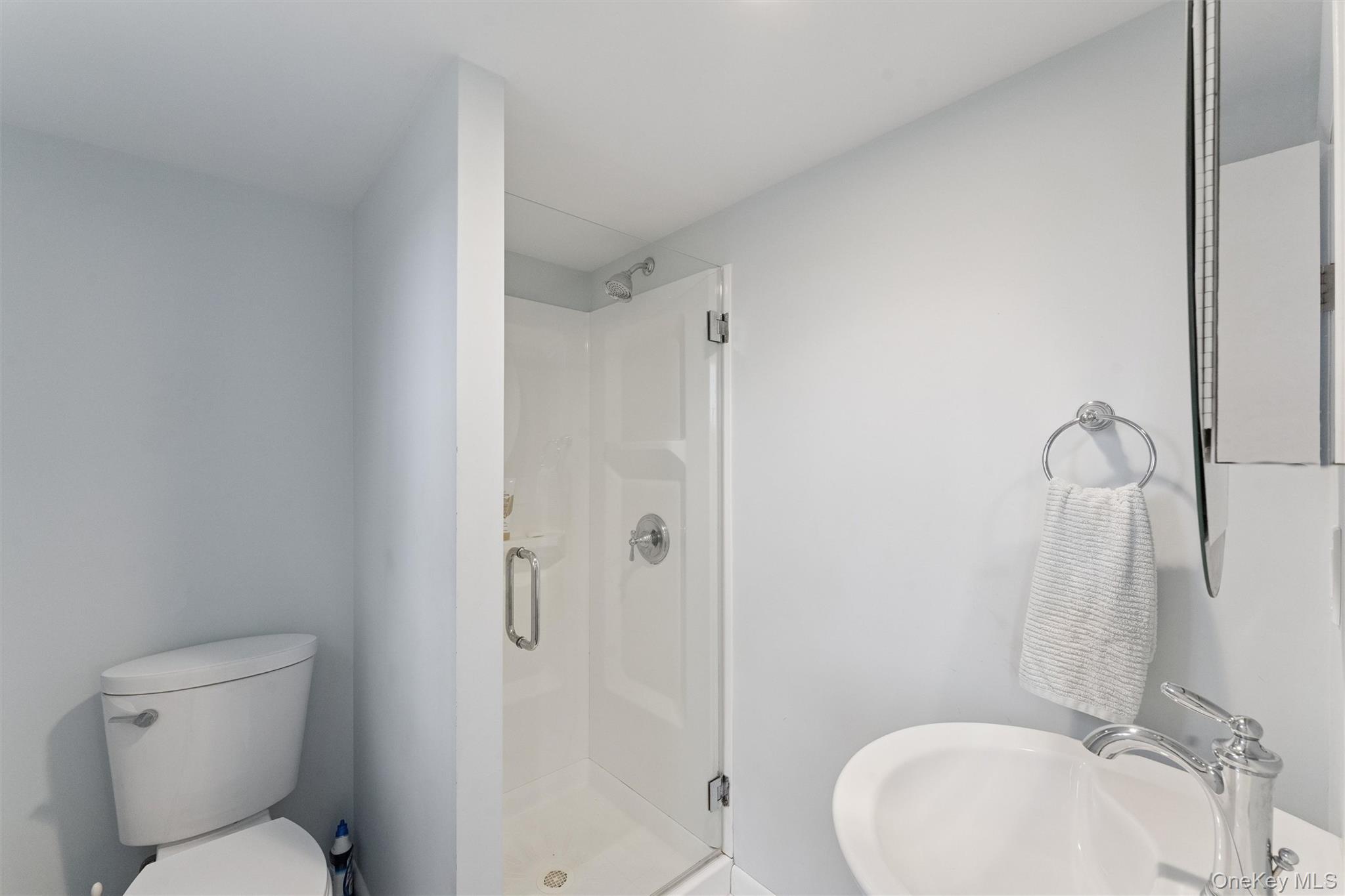 23 Old Main Road Quogue, NY 11959 - Photo 19 of 19 a bathroom with a sink toilet and shower