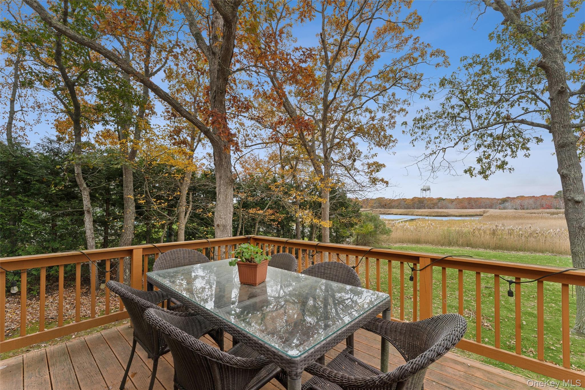 23 Old Main Road Quogue, NY 11959 - Photo 5 of 19 a view of a balcony with wooden floor and outdoor seating