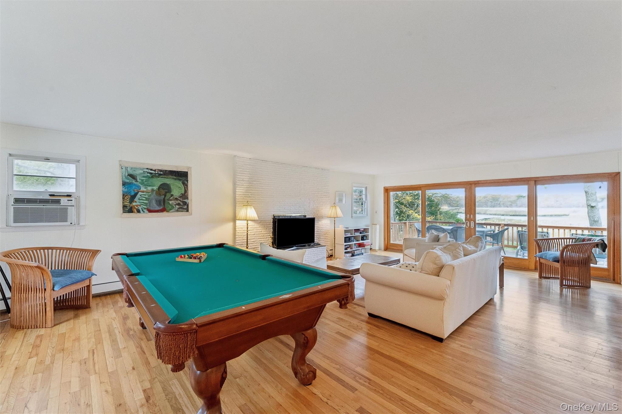 23 Old Main Road Quogue, NY 11959 - Photo 8 of 19 a living room with furniture and a flat screen tv
