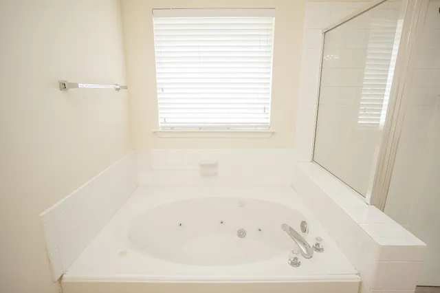 a white bath tub sitting next to a window