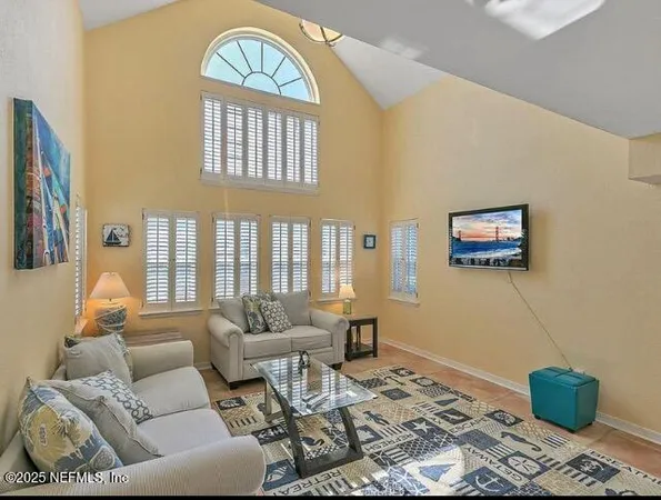 a kitchen with stainless steel appliances granite countertop a sink dishwasher a couches with wooden floor