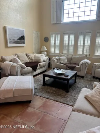 a bedroom with two beds and a lamp