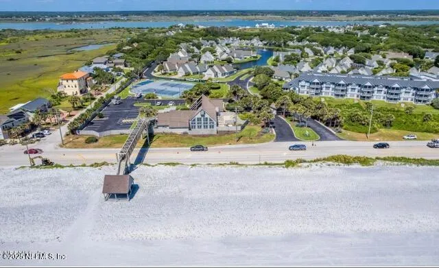 a aerial view of a house with a yard table and chairs