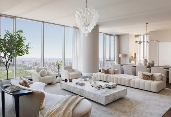 a living room with furniture potted plant and large windows