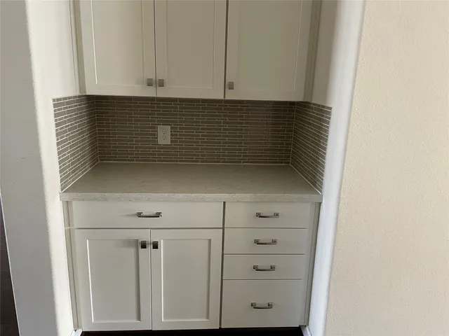 a view of storage and utility room with cabinet