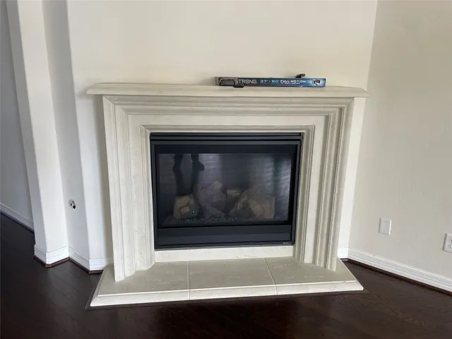 a close view of a fireplace with wooden floor