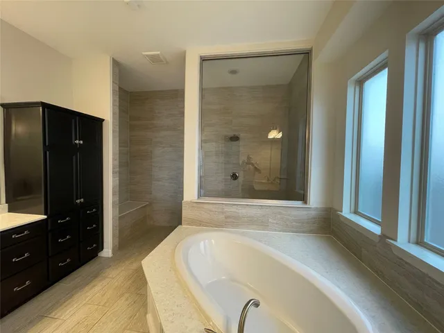 walk in closet with white cabinets