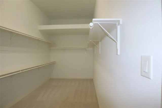 a view of a kitchen with kitchen island wooden floors appliances and cabinets