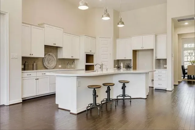 a kitchen with stainless steel appliances a stove a sink a refrigerator and cabinets